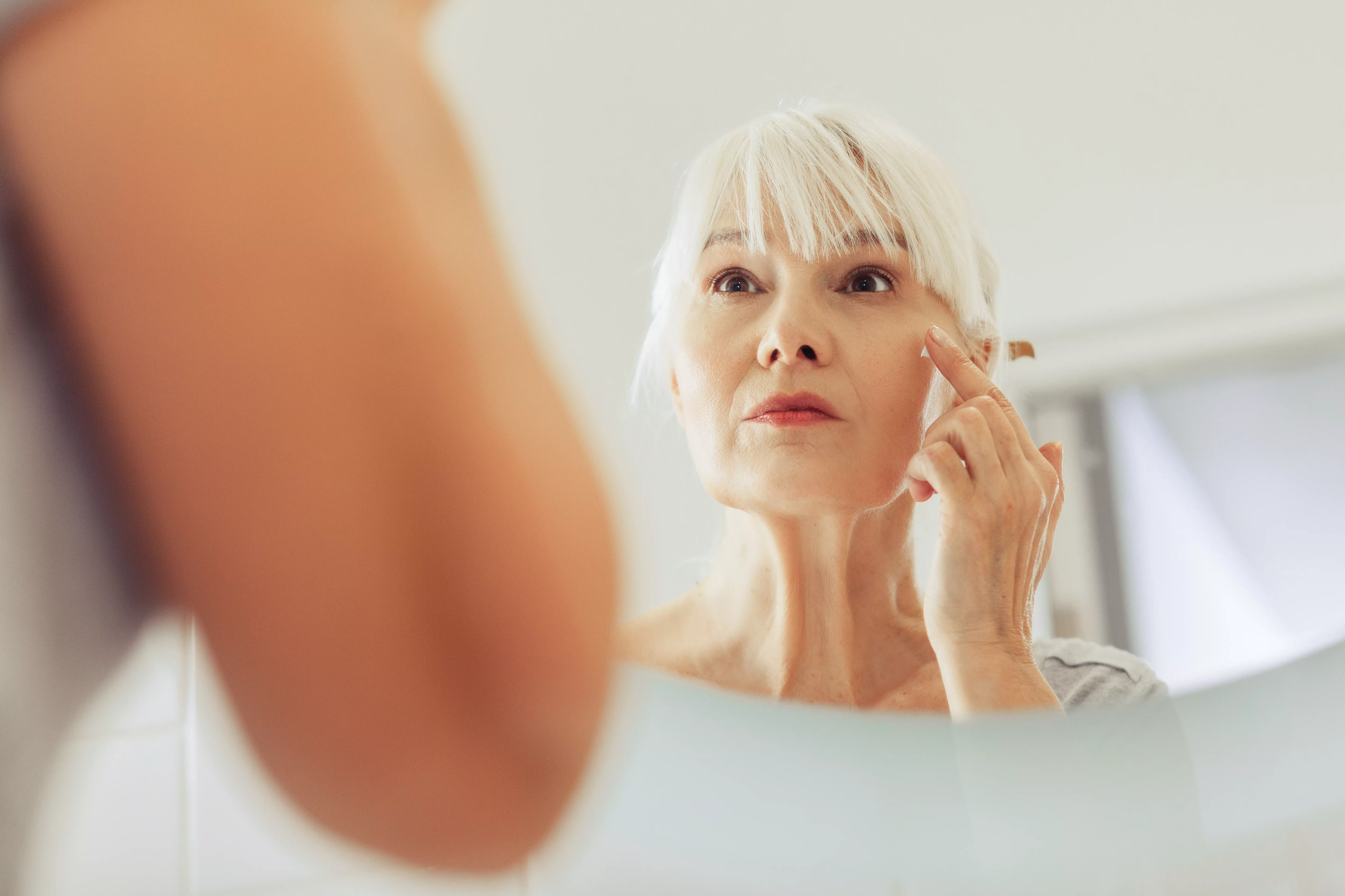 Menopausal woman skin in mirror